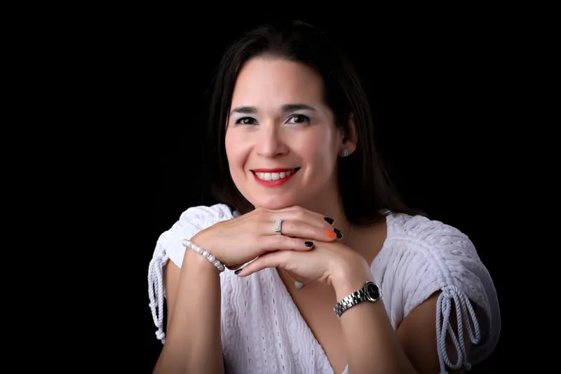 Erika J. Molina-Vergara, founder and CEO of Mindful Homes, smiling with her hands folded
